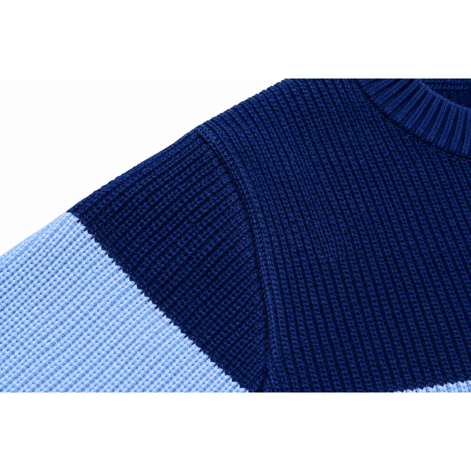 Close-up of the Colorblock Sporty Sweater kids’ sweater showing the navy and powder-blue knitted panels and shoulder seam.