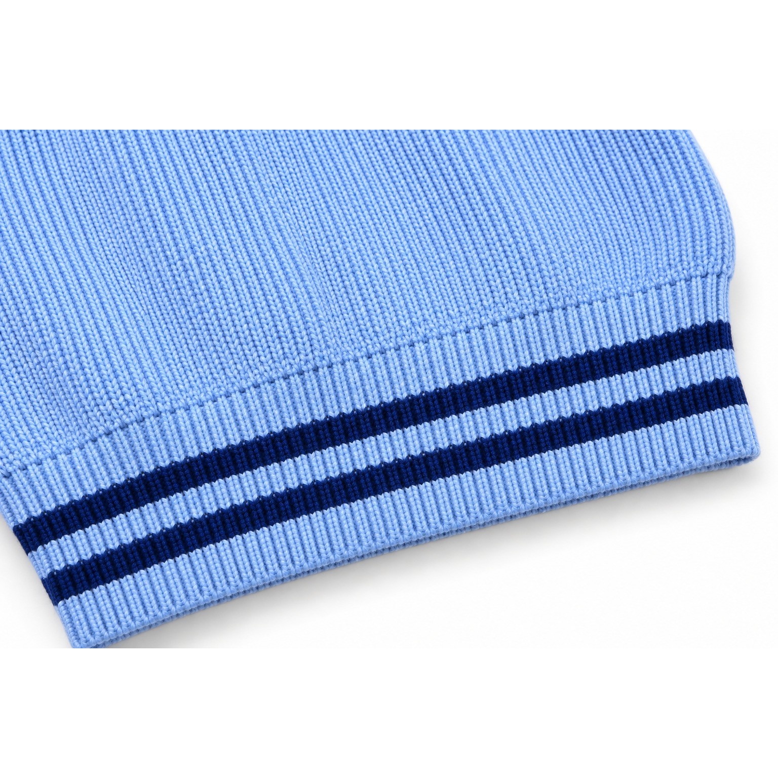Close-up of the Colorblock Sporty Sweater children’s sweater showing a powder-blue ribbed hem with two navy stripes.