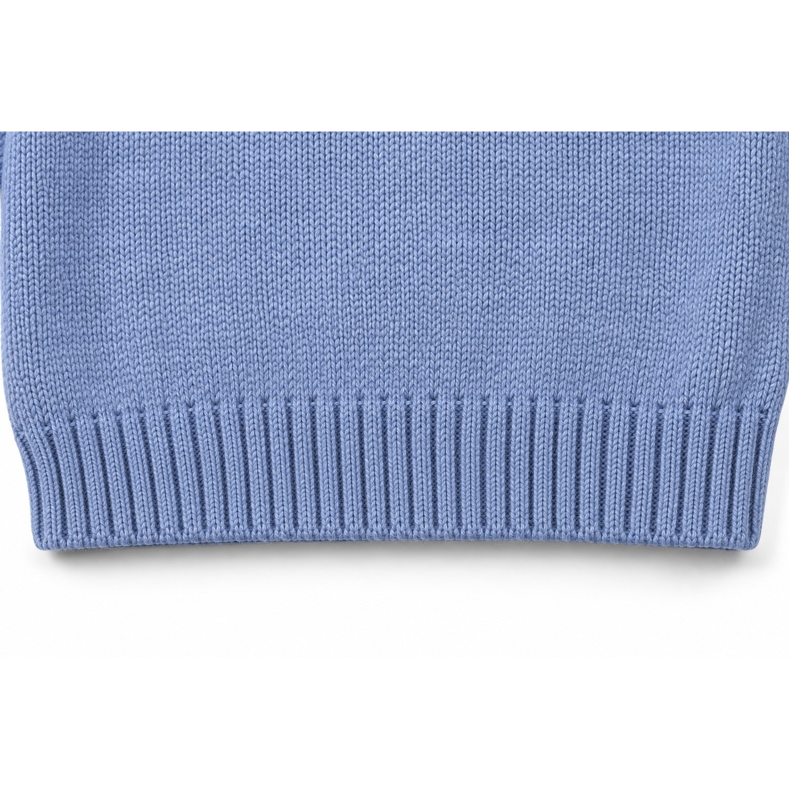 Close-up of the grey-blue Bunny Garden Embroidered Sweater children’s sweater knit and ribbed bottom hem.